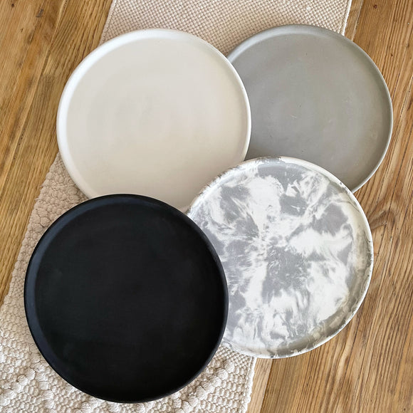 4 round concrete display trays in white, grey, black and white & grey marble effect