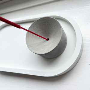 Marbled concrete incense holder on a white oval concrete tray 