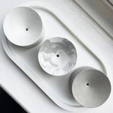 white, marble and grey concrete incense holders from above