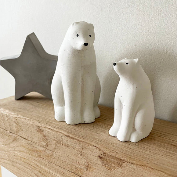 Concrete polar bear ornaments. Polar bear christmas decorations with grey concrete star ornament behind