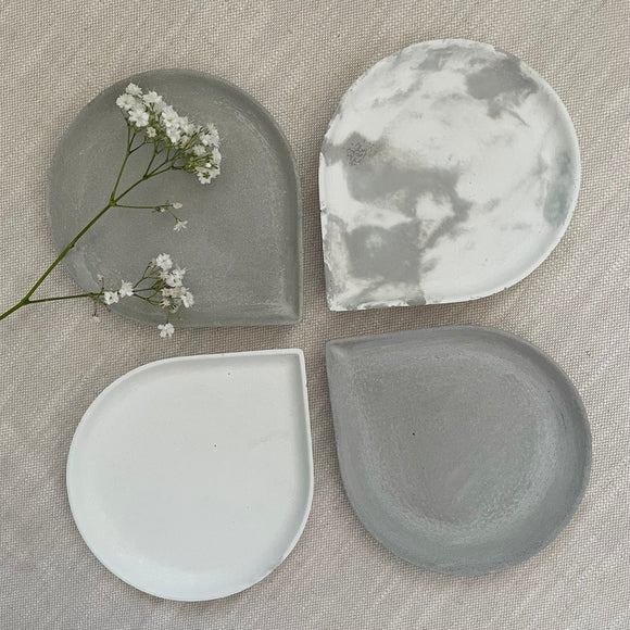 4 concrete teardrop shaped trinket dishes from above