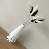 Dalmatian print tall concrete bud vase with monochrome bouquet of bunny tails